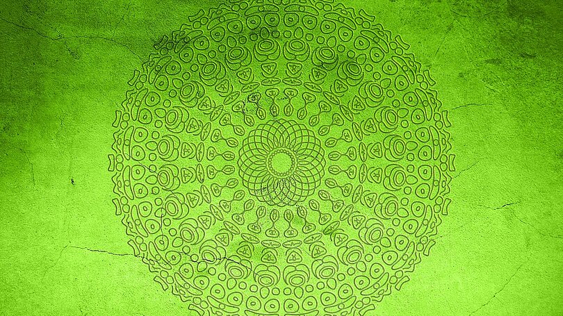 Ornamente in Form eines Mandalas auf hellgrünem Hintergrund